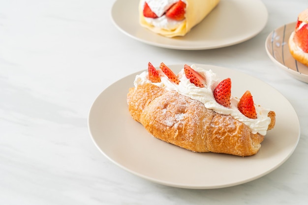 strawberry and fresh cream croissant on plate