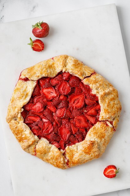 Strawberry galette Homemade baked cake with strawberry Open strawberry pie on marble board