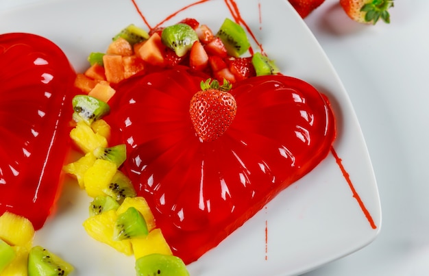 Strawberry gelatin decorated with fresh strawberry, kiwi and pineapple.