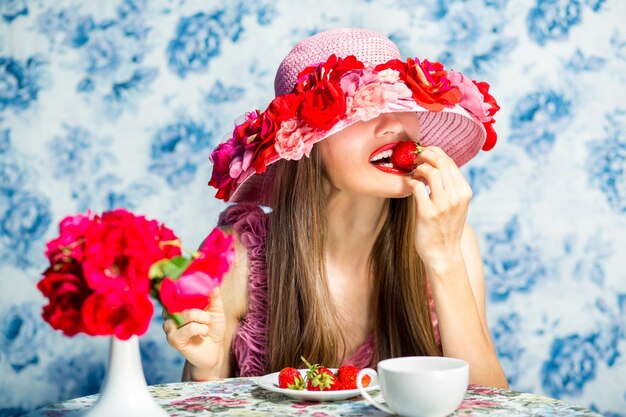 Strawberry girl Elegant lady wearing hat eating dessert