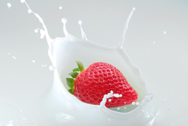 a strawberry in a glass of milk with a strawberry in it