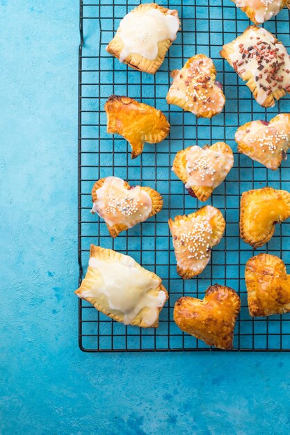 Strawberry heart pop tarts, shot from the top on a  concrete  background. Tasty toaster pastry