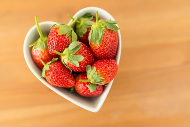 Strawberry in heart shape bowl