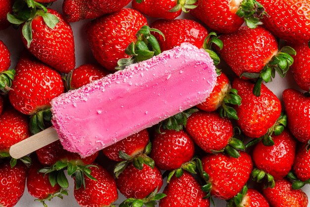 Strawberry ice cream on a background of fresh strawberries