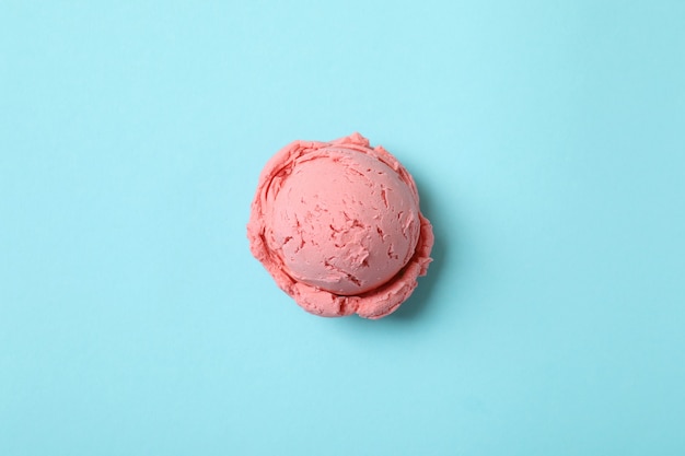 Strawberry ice cream ball on blue background