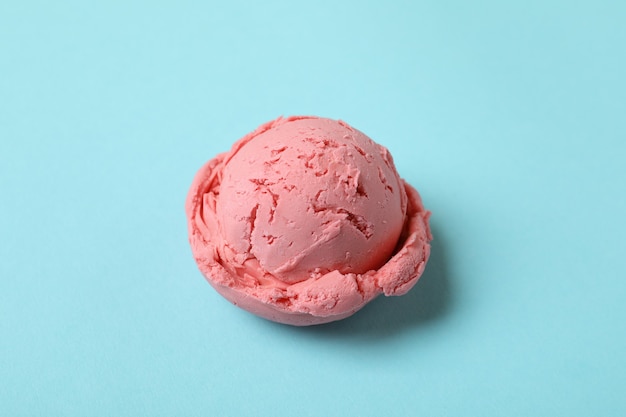 Strawberry ice cream ball on blue