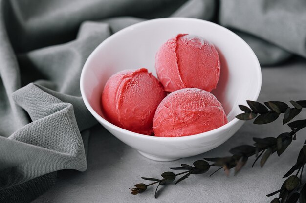 Strawberry ice cream balls in a white bowl