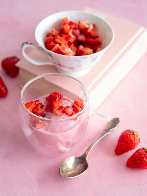 Strawberry ice cream in a glass cup. Yogurt ice cream. Diet, healthy eating. Fresh strawberries. Copy space, close up.