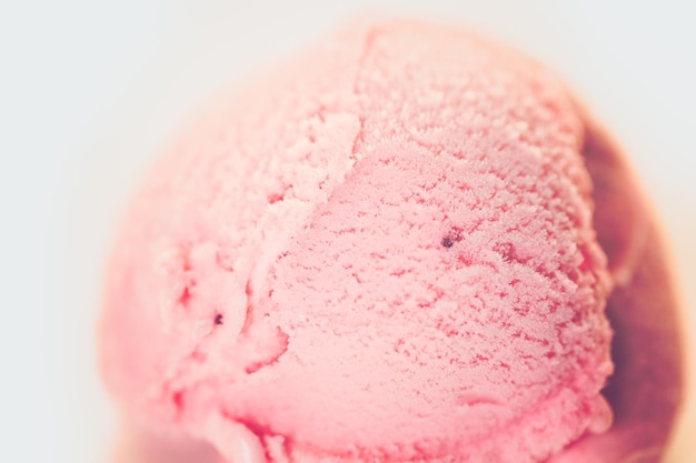 Strawberry ice cream scoop on a white background.