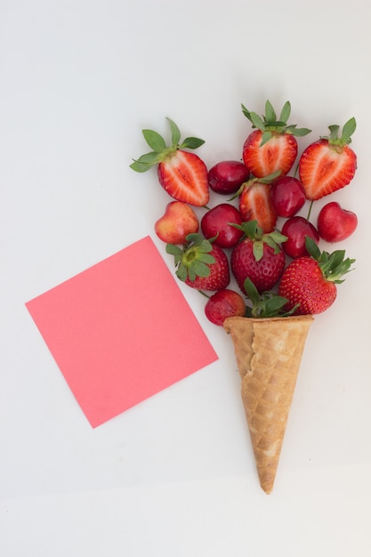 strawberry ice cream in a waffle cone