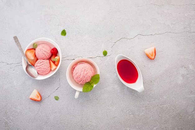 Strawberry ice cream with mint on a concrete table