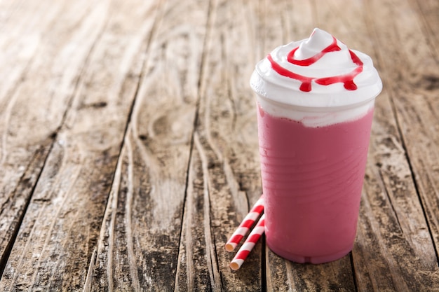 Strawberry iced milkshake on wooden table