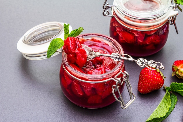 Strawberry jam in a glass jar.