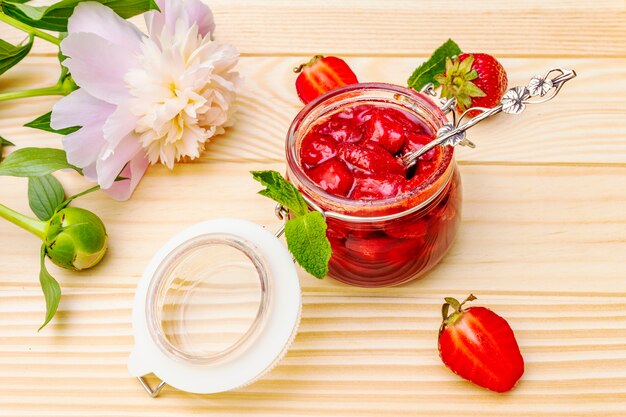 Strawberry jam in a glass jar.