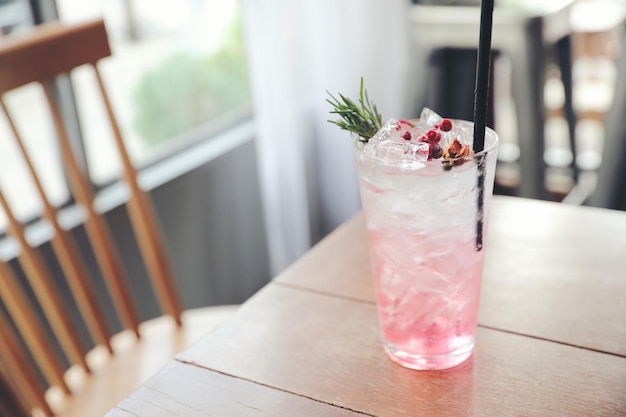 Strawberry juice cocktail with soda on wood background