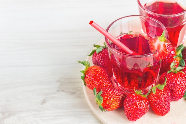 Strawberry juice surrounded by strawberries