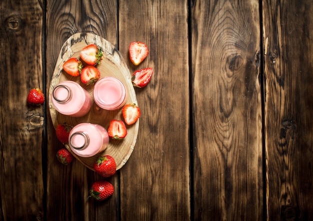 Strawberry juice on a tray. On wooden table.