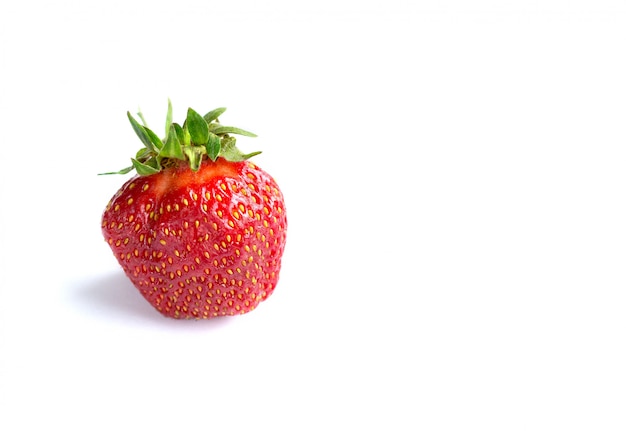 Strawberry lies on a white