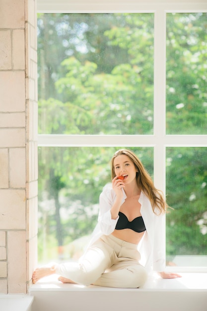 Strawberry lips Beautiful young shirtless woman holding strawberry in her hand and tasting