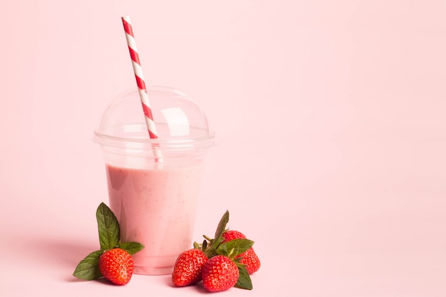 Strawberry milkshake near strawberry fruits