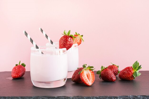 Strawberry milkshake on pink.