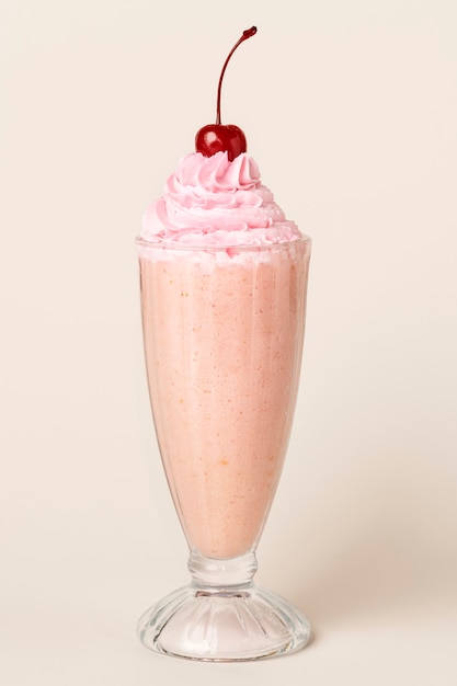 Strawberry milkshake with a maraschino cherry on top