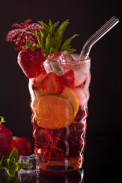 Strawberry mojito cocktail at the bar. Mojito cocktail over black background. Cocktail Mojito in the nightclub