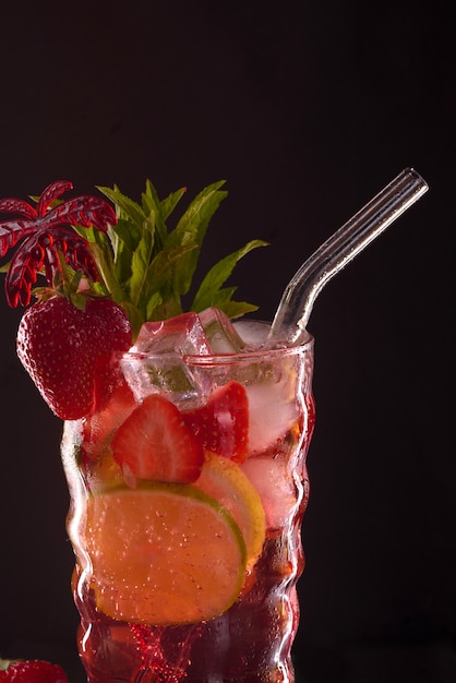 Strawberry mojito cocktail at the bar. Mojito cocktail over black background. Cocktail Mojito in the nightclub