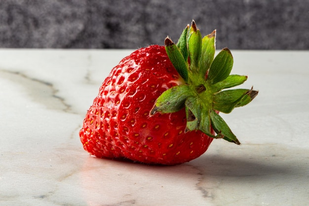 Strawberry in natura on white marble stone