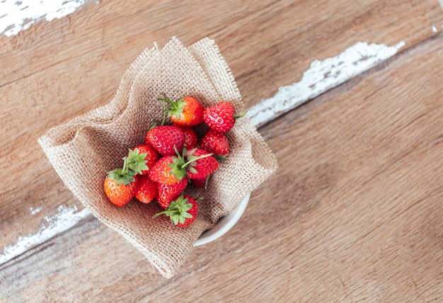 Strawberry on old wooden table,