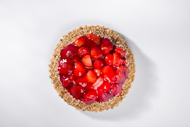 Torta di fragole su sfondo bianco vista dall'alto.