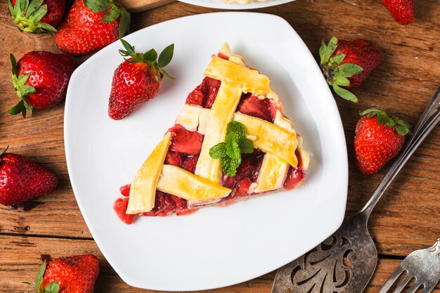 The strawberry pie in the wooden background