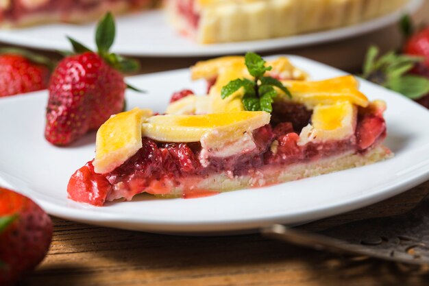 The strawberry pie in the wooden background