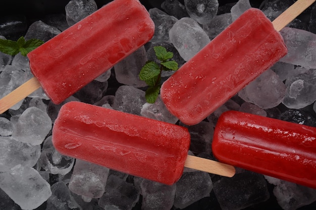 Strawberry popsicle on blue background