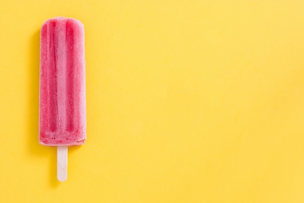 Strawberry popsicle on yellow