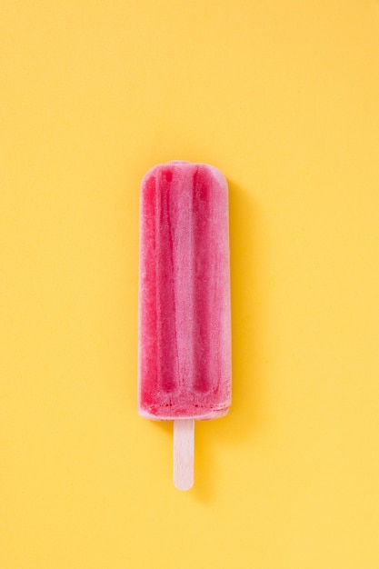 Strawberry popsicle on yellow