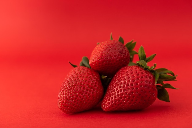 Photo strawberry on a red background