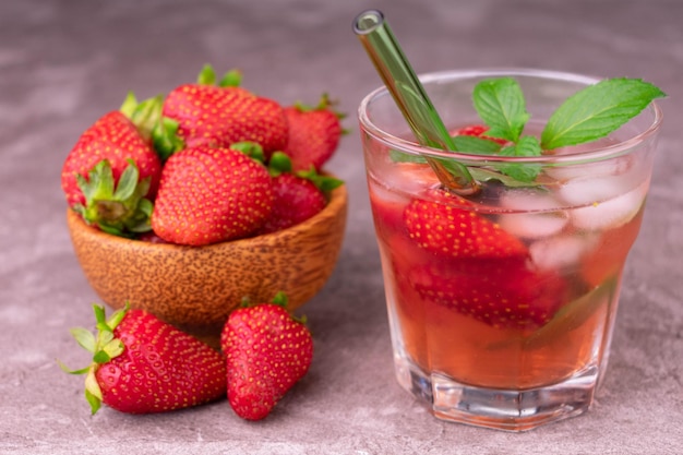 Strawberry refreshing drink with mint on a gray background Closeup