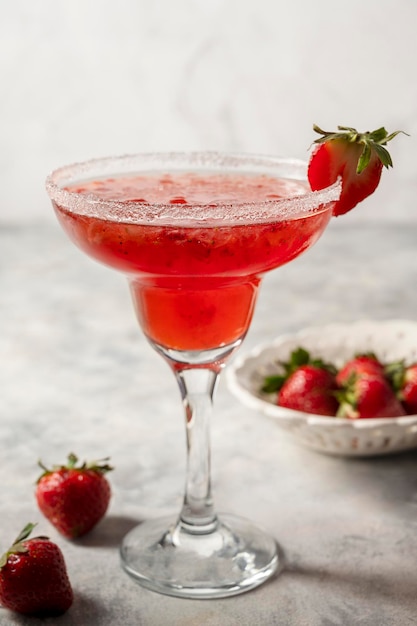 Strawberry refreshing margarita in tall footed glasse with fresh strawberries