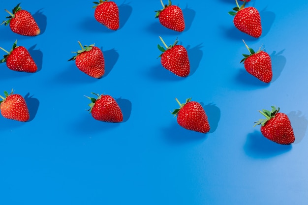 Strawberry ripe fruit on blue wall