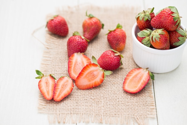 Strawberry's cut on a white wooden table.