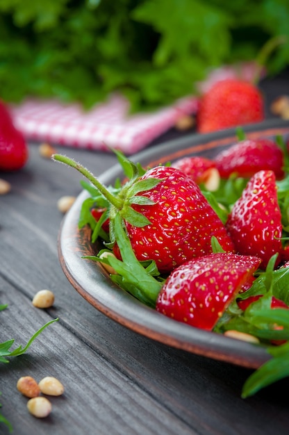 Strawberry salad with arugula, nuts, and honey