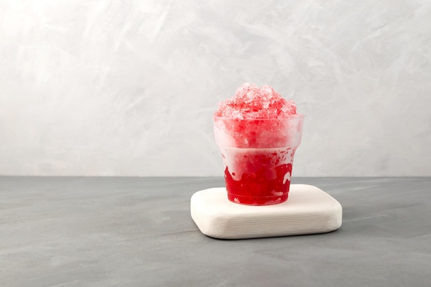 Strawberry Slushie in plastic cup Sweet shaved ice Spanish fruit granizado Refreshing summer drink