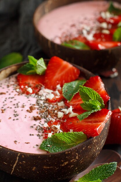 Strawberry smoothie bowls topped with fresh strawberries and mint