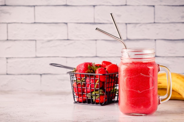 Strawberry smoothie or cocktail in the glass jar