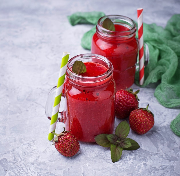 Strawberry smoothie in glass jars. Selective focus. Square image