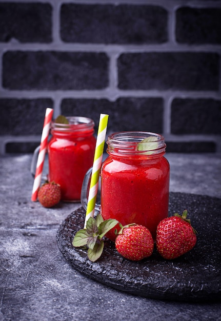 Strawberry smoothie in glass jars. Selective focus