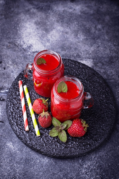 Strawberry smoothie in glass jars. Selective focus