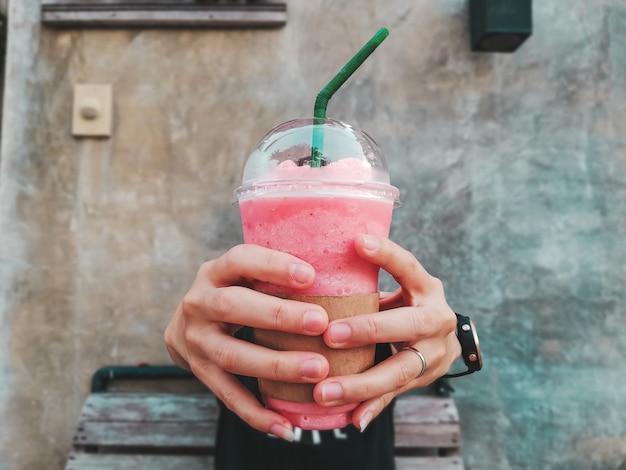 Strawberry smoothie in hand