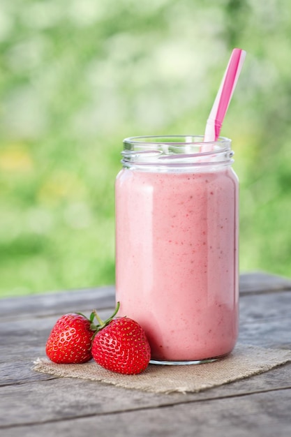 strawberry smoothie in jar Milkshake Healthy summer drink concept Berry cocktail